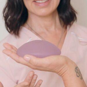 How can you achieve cleavage with breast implants?